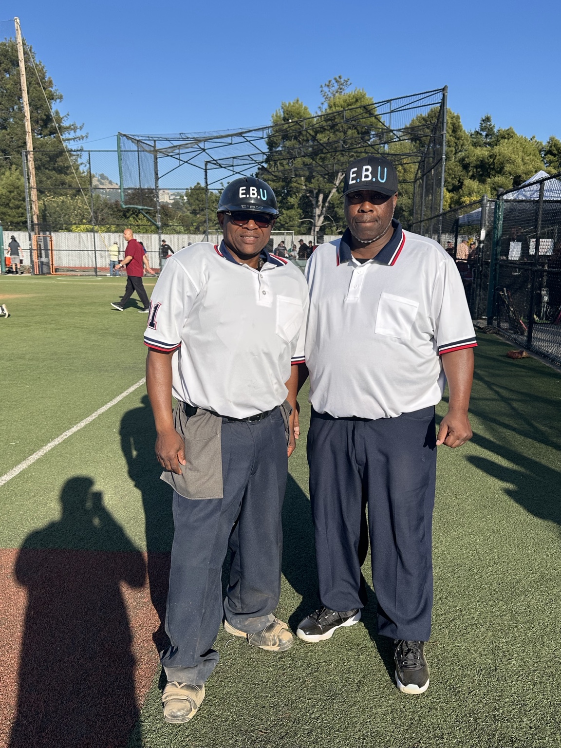 Two EBU officials in uniform on a baseball field